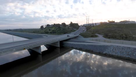 Aerial-drone-view-as-cars-drive-across-a-bridge