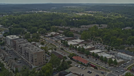 Woodstock-Georgia-Aerial-v3-dolly-out-shot-of-traffic,-low-rise-neighborhood-and-forest---DJI-Inspire-2,-X7,-6k---August-2020