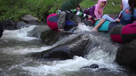 Yogyakarta,-Indonesia---Okt-29,-2020-:-children-playing-in-the-river-using-life-tubes