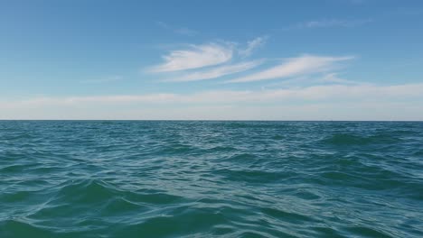 Low-angle-water-surface-personal-perspective-of-boat-sailing-in-open-sea