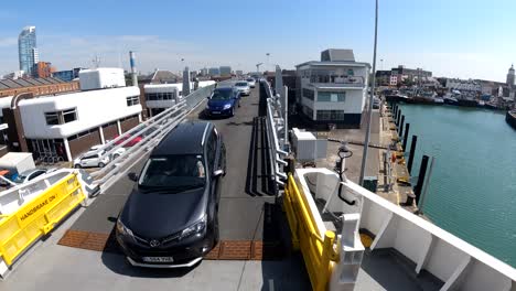 Time-lapse-view-of-cars-loading-onto-a-ferry-at-Portsmouth,-UK-ready-to-travel-across-the-solent-to-the-Isle-Of-Wight