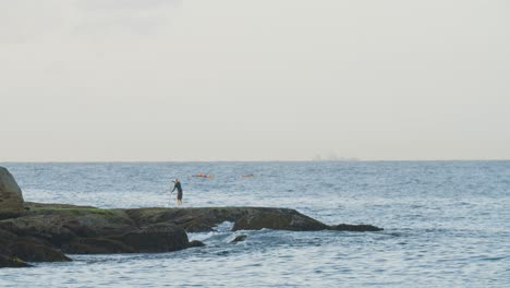 Elderly-Man-Enjoying-Nature-on-Ocean-with-SUP-Paddleboard-in-Australia