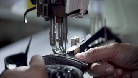 Closeup-Of-Leather-Gloves-Stitched-On-Sewing-Machine-In-Manufacturing-Factory
