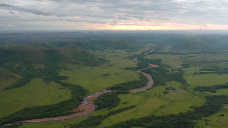 Aerial-view-of-a-river-flowing-through-the-grassland-of-Uruguay
