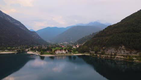 Fantastic-shot-of-a-divine-beauty-lake-ledro-and-lovely,-tucked-in-settlement-at-the-foot-of-the-mountain