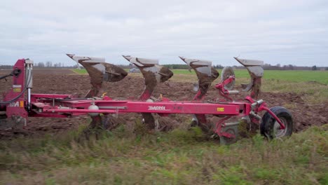 Tractor-Ploughing-The-Field-with-Agrolux-machine-For-Planting-Preparation-During-Daytime---Close-Up-Shot