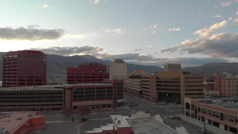 Rising-aerial-of-light-morning-city-traffic-and-Rocky-Mountains-beyond