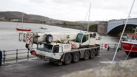 Industrial-hydraulic-crane-vehicle-logistics-on-Conwy-Wales-harbour-waterfront