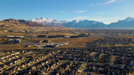 Silicon-Slopes-in-Lehi-and-Highland-Utah---aerial-push-in-view-of-a-picturesque-community-below-the-snowy-mountains