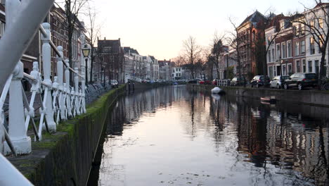 Timelapse-pan-of-dutch-canals-with-driving-boat-during-sunset-in-Leiden,Netherlands