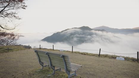 Takeda-Castle-Ruins,-Bench-chair-looking-over-endless-valley-of-mist,-Japan