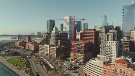 A-coastal-city-with-buildings-roads-and-a-red-crane