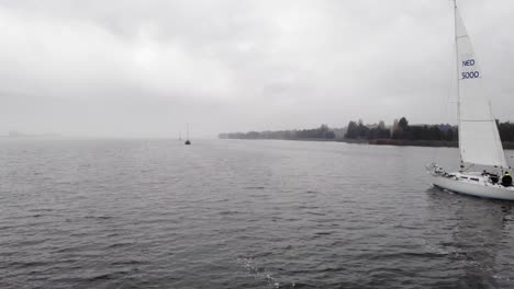 Sailing-vessel-proceeding-on-a-Dutch-lake-her-voyage-during-a-cloudy-day-in-the-autumn