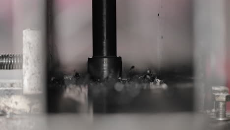 Automated-Iron-Piercing-Machine-Drilling-Hole---Closeup-Shot