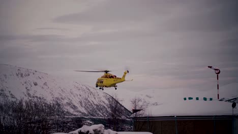 Yellow-air-ambulance-helicopter-taking-off-from-UNN-hospital-in-Tromso