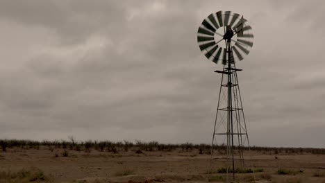 This-old-windmill-turns-to-face-the-oncoming-storm-generating-power,-or-pumping-water-as-it-turns