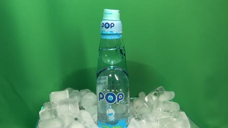 3-3-Best-Selling-Japanese-clear-Carbonated-Flavoured-drink-called-Marble-Pop-ball-activated-carbonation-under-lid-to-preserve-the-rich-taste-rotating-360-degrees-on-ice-bowl-in-front-of-green-screen