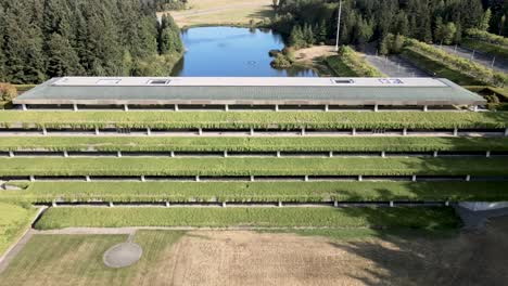Flying-back-and-revealing-the-vine-covered-Weyerhaeuser-Corporate-Headquarters-building,-aerial