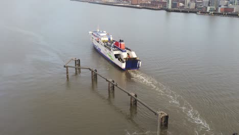 Stena-Line-logistics-ship-leaving-port-aerial-view-Birkenhead-Liverpool-harbour-city-landscape-tilt-up