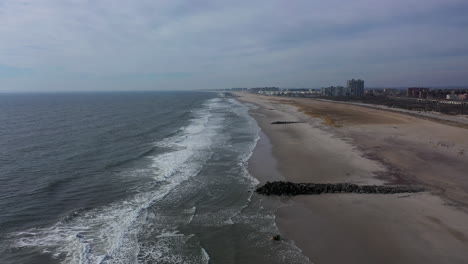 A-drone-view-of-an-empty-beach-on-a-cloudy-day