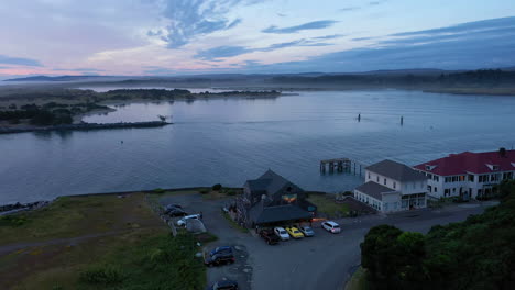 Customers-At-Edgewaters-Restaurant-At-The-Mouth-Of-Coquille-River-In-Bandon,-Oregon-Amidst-Covid-19-Pandemic-In-The-US---aerial-drone