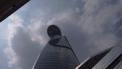 Looking-up-rotating-shot-of-Bitexco-financial-tower-and-sky-in-the-financial-district-of-Saigon-or-Ho-Chi-Minh-City,-Vietnam
