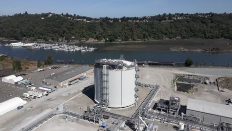 Passing-over-Puget-Sound-Energy's-LNG-plant-located-on-the-port-of-Tacoma,-aerial