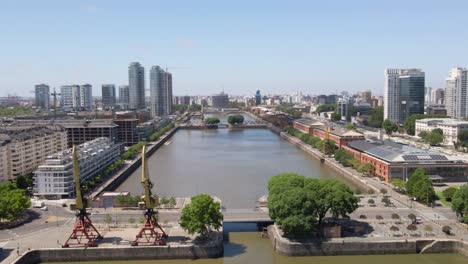 Aerial-panning-shot-of-Puerto-Madero-docks-and-Buenos-Aires-skyline,-Argentina