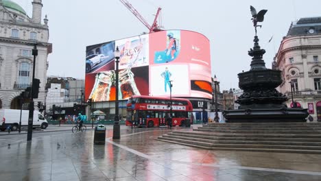 London-bus-drives-behind-abandoned-Piccadilly-Circus-Covid-Lockdown