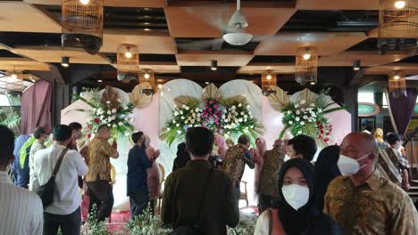 Indonesian-traditional-wedding-party-reception,-people-shake-hands-with-the-bride-and-groom-as-a-sign-of-congratulations-on-marriage