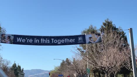 "We-are-in-this-together"---A-large-banner-reminding-people-to-stay-strong-during-a-new-stay-at-home-order-in-the-Bay-Area-as-COVID19-patients-take-up-more-ICU-beds-in-hospitals-than-ever-before