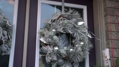 White-Christmas-wreath-at-entrance-of-house-with-Double-Door