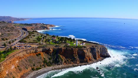 Slow-aerial-drone-view-flying-towards-the-light-house-on-the-cliffs-of-Rancho-Palos-Verdes-in-Southern-California
