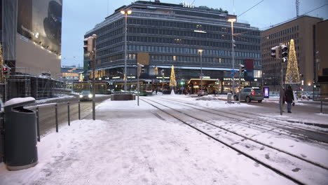 Modern-articulated-tram-moving-on-the-snowy-streets-in-Helsinki,-Finland