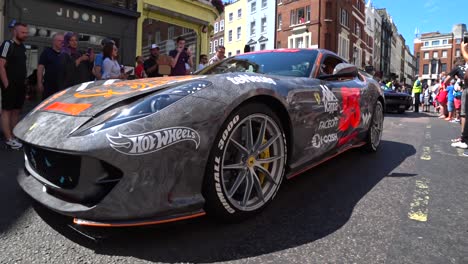 Low-angle-shot-of-luxury-ferrari-with-police-lights-and-ford-mustang-on-stage