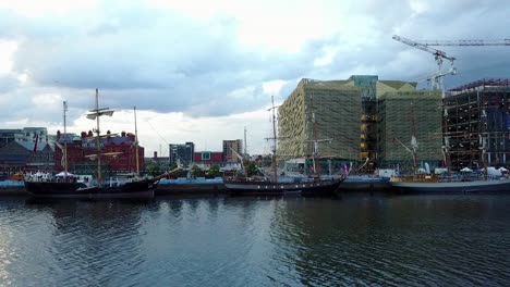 Pan-shot-of-Dublin-docklands-north-side-with-boats-and-buildings-under-construction