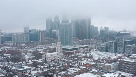 Cinematic-rotating-drone-shot-of-City-of-London-covered-in-snow