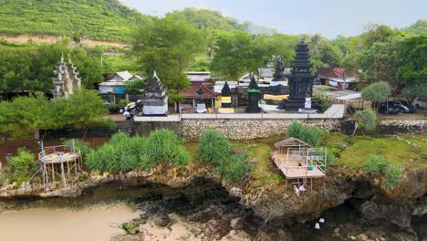 Ancient-Hindu-Temple-on-Ngobaran-Beach-and-scenic-coast-of-Java-Indonesia-aerial