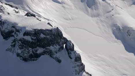 Stunning-aerial-view-of-snowcapped-Mount-Garibaldi-Mountain-lighting-during-sunlight