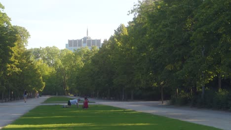 Man-and-woman-in-Brussels-Royal-park-doing-a-workout-on-grass-field