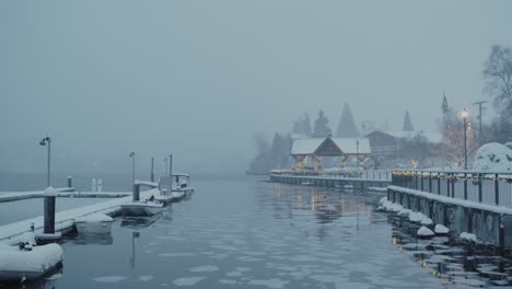 An-early-winter-morning-on-the-Poulsbo-Harbor-during-a-rare-Seattle-snow-storm,-looking-out-at-the-boardwalk