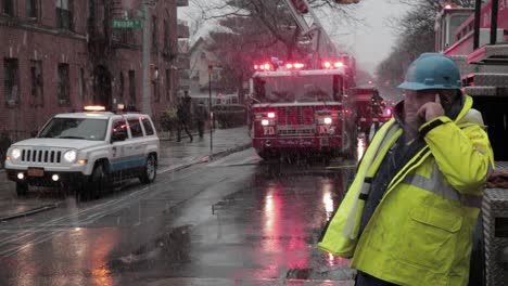 ConEd-employee-assessing-accident-under-heavy-snowfall-on-Brooklyn-Street---Medium-Pan-shot