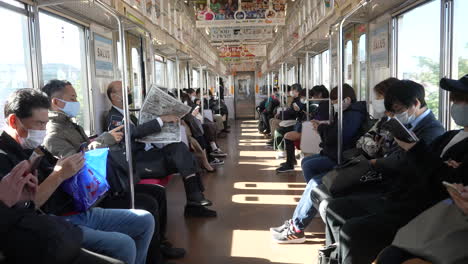 Everyone-Riding-On-Train-Wearing-Facemask-Due-To-Worldwide-Pandemic-For-Protection-In-Tokyo,-Japan