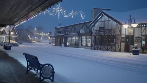 Early-morning-in-Poulsbo-Washington-with-a-rare-snowfall,-a-view-of-downtown-and-a-bench