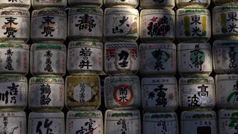 Slow-left-walking-among-famous-Sake-Barrels-at-Meiji-Shrine-in-Tokyo---Close-up