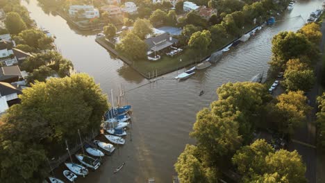 Aerial-parallax-shot-of-canals-in-San-Isidro-city,-Greater-Buenos-Aires-at-golden-hour