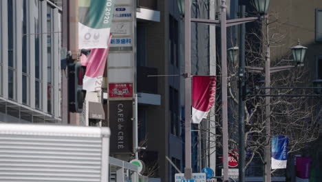 A-slow-motion-shot-of-the-cancelled-Tokyo-2020-Olympic-banners-in-the-city-in-Tokyo,-Japan