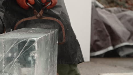 Ice-tongs-clamping-into-and-moving-large-block-of-ice,-Slow-Motion