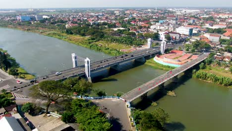 Panoramic-aerial-view-of-Brantas-river-and-Brawijaya-bridge-in-Kediri,-Indonesia