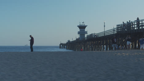 Seal-Beach-pier-with-a-guy-on-his-cellphone